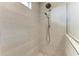 Modern shower features grey tile, glass enclosure and mosaic tile flooring at 611 W Olympia Ave, Punta Gorda, FL 33950
