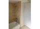 Bathroom with bathtub and beige tile surround at 3100 Harbor Blvd # 116, Port Charlotte, FL 33952