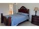 Bright bedroom with double bed, dresser, and ensuite bathroom access at 3100 Harbor Blvd # 116, Port Charlotte, FL 33952