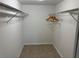 Spacious walk-in closet with wire shelving and wooden hangers at 3100 Harbor Blvd # 116, Port Charlotte, FL 33952