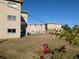 Building exterior with a pool and grassy yard at 3100 Harbor Blvd # 116, Port Charlotte, FL 33952