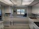 Kitchen with a breakfast bar and view to the living room at 3100 Harbor Blvd # 116, Port Charlotte, FL 33952