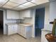 White kitchen with an abundance of cabinet and counter space at 3100 Harbor Blvd # 116, Port Charlotte, FL 33952