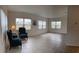 Living room with tile floors, multiple windows, and two armchairs at 3100 Harbor Blvd # 116, Port Charlotte, FL 33952