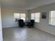 Living room with tile floors and two armchairs by the window at 3100 Harbor Blvd # 116, Port Charlotte, FL 33952