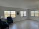 Living room with tile floors and large windows offering natural light at 3100 Harbor Blvd # 116, Port Charlotte, FL 33952
