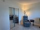 Relaxing office space with a comfortable recliner chair and mirrored closet at 3100 Harbor Blvd # 116, Port Charlotte, FL 33952