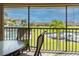 Scenic balcony view overlooking marina, pool, and lush landscape at 3256 White Ibis Ct # 13B, Punta Gorda, FL 33950