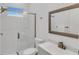 Well-lit bathroom with a glass shower door, modern fixtures, and white tile at 13454 Ingraham Blvd, Port Charlotte, FL 33981