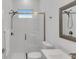 Modern bathroom featuring tiled shower with glass door, toilet, and vanity with sink at 13454 Ingraham Blvd, Port Charlotte, FL 33981