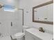 Bright bathroom with a glass shower door, modern fixtures, and white tile at 13454 Ingraham Blvd, Port Charlotte, FL 33981