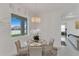 Chic dining area with modern chandelier, glass table, and view to the backyard at 13454 Ingraham Blvd, Port Charlotte, FL 33981