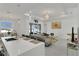 Living room and kitchen combo featuring an open concept, lots of lighting and neutral-toned decor at 13454 Ingraham Blvd, Port Charlotte, FL 33981