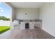 Outdoor kitchen featuring a built-in grill, sink, mini-fridge, and granite countertops at 13454 Ingraham Blvd, Port Charlotte, FL 33981