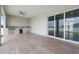 Spacious covered patio featuring wood-look tile floors and an outdoor kitchen with grill and mini fridge at 13454 Ingraham Blvd, Port Charlotte, FL 33981