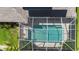 Aerial view of a home with a screened pool and solar panels at 2556 Saturday St, North Port, FL 34288