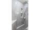 Modern bathroom with a large shower, built-in shelves, and gray tile at 2556 Saturday St, North Port, FL 34288