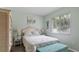 Cozy bedroom with a wicker bed frame and a teal bench at the foot of the bed at 2556 Saturday St, North Port, FL 34288