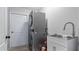 Laundry room with a stackable washer and dryer and a utility sink at 2556 Saturday St, North Port, FL 34288