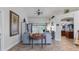 Living room with gray sofa and view into kitchen at 2556 Saturday St, North Port, FL 34288