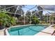 Inviting screened pool with lush landscaping at 2556 Saturday St, North Port, FL 34288