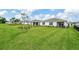 Large backyard with green grass and screened patio at 42392 Cascade Dr, Punta Gorda, FL 33982