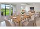 Bright dining room with wooden table and chairs, view of backyard at 42392 Cascade Dr, Punta Gorda, FL 33982