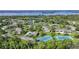 Aerial view of waterfront condo community with tennis courts nearby at 4260 Placida Rd # 15D, Englewood, FL 34224