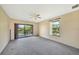 Main bedroom with sliding doors to balcony and window at 4260 Placida Rd # 15D, Englewood, FL 34224