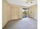 Bright bedroom with ceiling fan and sliding glass doors to balcony at 4260 Placida Rd # 15D, Englewood, FL 34224