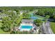 Community pool with surrounding lounge chairs and a clubhouse at 4260 Placida Rd # 15D, Englewood, FL 34224