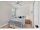 Charming bedroom with a full-size bed and a window with shutters at 1289 Ballota Ln, North Port, FL 34289