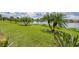 Scenic lakefront property with lush landscaping and palm trees at 1289 Ballota Ln, North Port, FL 34289