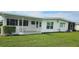 View of the back of the house with a covered patio and lush landscaping at 22580 Bolanos Ct, Port Charlotte, FL 33952