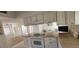 White kitchen with an island, built-in oven, and a view of the living area at 22580 Bolanos Ct, Port Charlotte, FL 33952