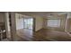 Spacious living room with wood-look floors and sliding glass doors at 22580 Bolanos Ct, Port Charlotte, FL 33952