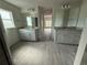 Double vanity bathroom with gray cabinets and tile floors at 49 Tee View Rd, Rotonda West, FL 33947