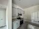 Modern kitchen with stainless steel appliances and gray cabinets at 49 Tee View Rd, Rotonda West, FL 33947