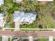 Top-down view of a home with a metal roof, pool, and tropical landscaping at 116 Dolly St, Punta Gorda, FL 33950
