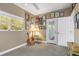 Charming bedroom with a wall of art and access to a balcony at 116 Dolly St, Punta Gorda, FL 33950