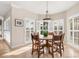 Bright dining area with a wooden table and white plantation shutters at 116 Dolly St, Punta Gorda, FL 33950