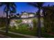 Two-story home with a spacious front yard, palm trees, and a brick driveway at 116 Dolly St, Punta Gorda, FL 33950