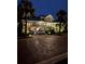 Two-story house with a metal roof and brick driveway, illuminated at night at 116 Dolly St, Punta Gorda, FL 33950