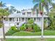 Two-story house with a metal roof, landscaping, and a brick driveway at 116 Dolly St, Punta Gorda, FL 33950