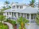 Two story house with gray metal roof, white siding, and lush landscaping at 116 Dolly St, Punta Gorda, FL 33950