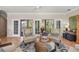 Comfortable living room with access to a private balcony and views of nature at 116 Dolly St, Punta Gorda, FL 33950