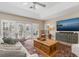 Spacious living room with large TV, comfortable seating, and access to a deck at 116 Dolly St, Punta Gorda, FL 33950