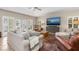 Cozy living room with large TV, comfortable seating, and tiled floors at 116 Dolly St, Punta Gorda, FL 33950