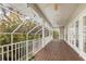 Spacious screened balcony with wooden deck and lush tropical views at 116 Dolly St, Punta Gorda, FL 33950