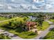 Aerial view of single-Gathering home with pool and lush landscaping at 24087 Santa Inez Rd, Punta Gorda, FL 33955